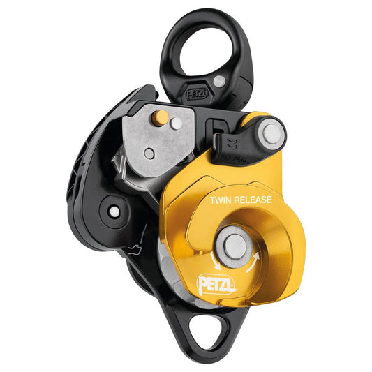 Releasable, the TWIN RELEASE progress capture pulley is designed to set up 4:1 haul systems for work in confined spaces or for technical rescue. Releasing the cam is possible with the ergonomic handle. The brake integrated into the moving side plate and the main faceted sheave with single-direction rotation, offer additional braking and better control when lowering heavy loads. The two sheaves provide excellent hauling efficiency. The swivel facilitates operations, allowing the pulley to be oriented under